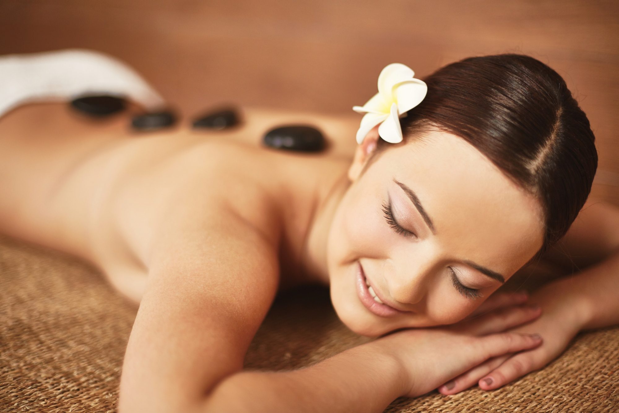 Hot stone massage at The Bali Spa & Wellness with heated stones placed along the back for deep relaxation
