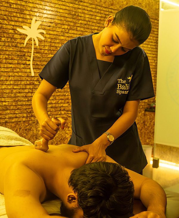 Balinese massage therapy by certified therapist at The Bali Spa & Wellness, providing deep relaxation and muscle relief in a hygienic spa setting