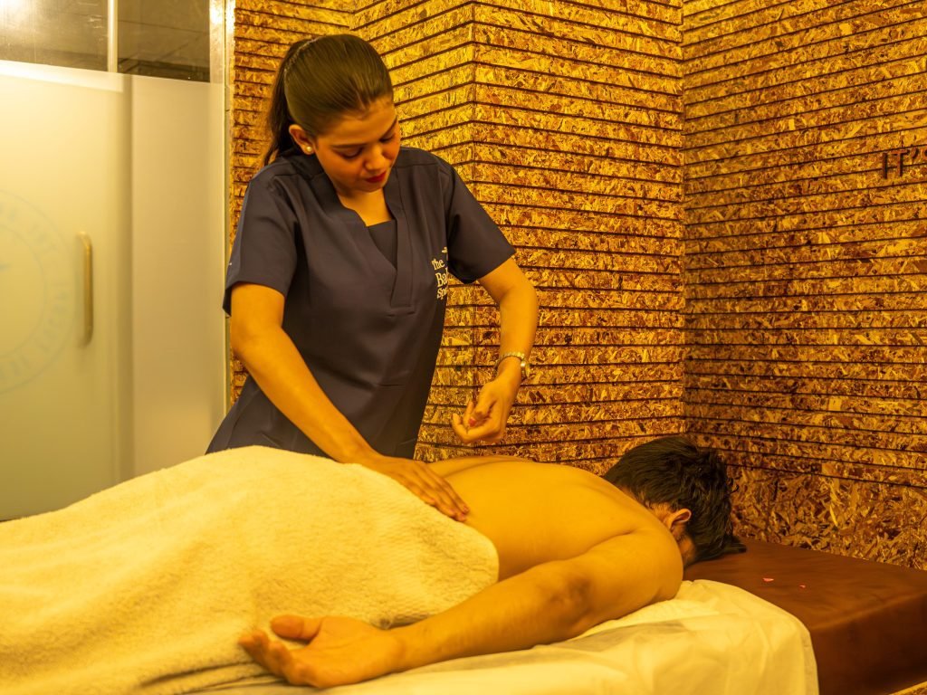 Therapist giving a relaxing back massage to a male client at The Bali Spa, a spa in Hyderabad